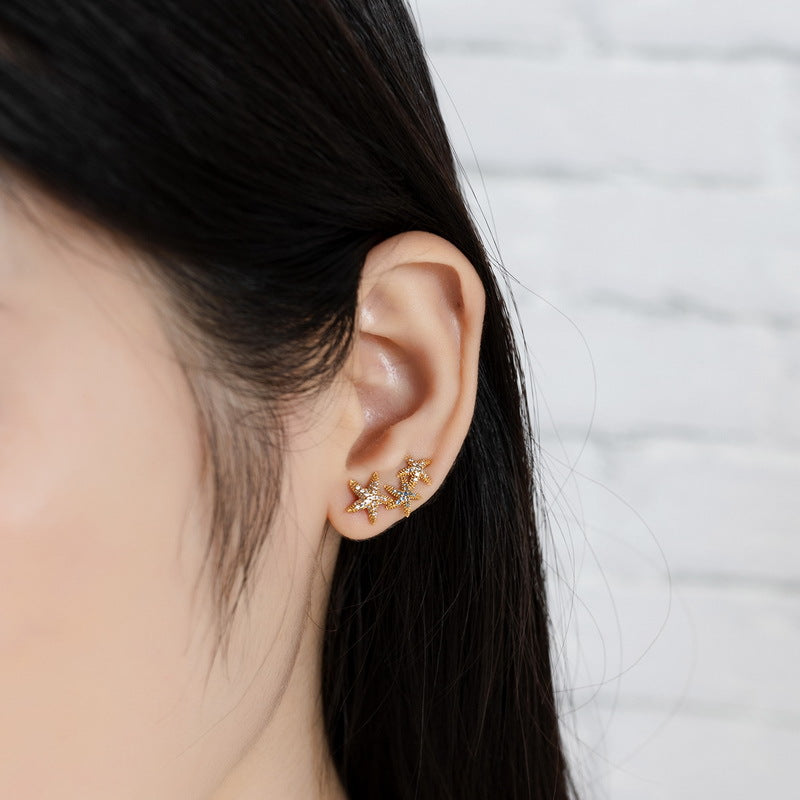 S925 sterling silver plated with 9K gold European and American style blue spinel white zircon starfish earrings can be worn sideways