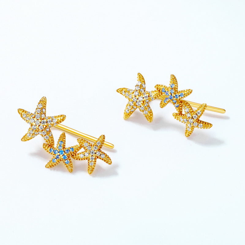 S925 sterling silver plated with 9K gold European and American style blue spinel white zircon starfish earrings can be worn sideways